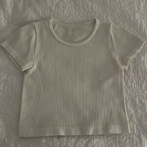 The color is white and is a striped shirt. Can be used as an exercise shirt.